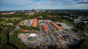 An aerial photo of the state Farmer's Market with downtown Raleigh skyline in the background. Photo by Marc Hall at NC State University.